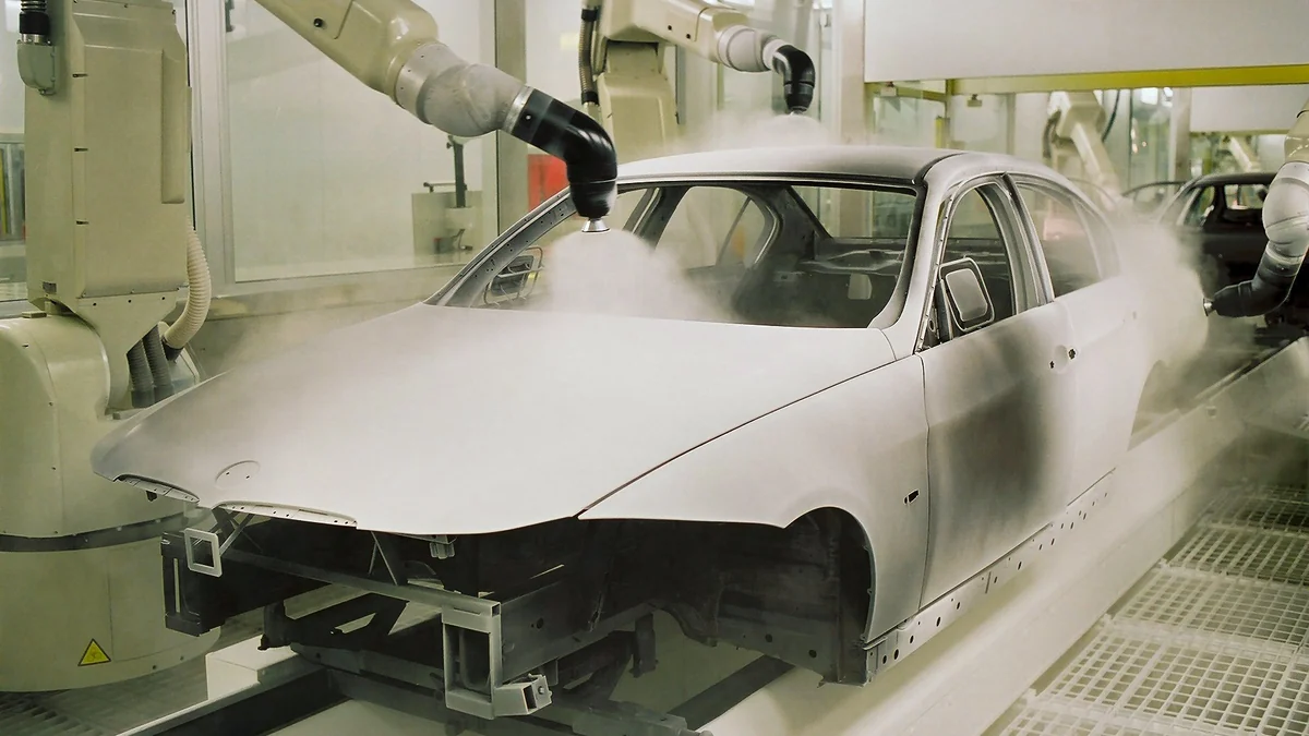 Automotive paint line showing spray painting for metal parts