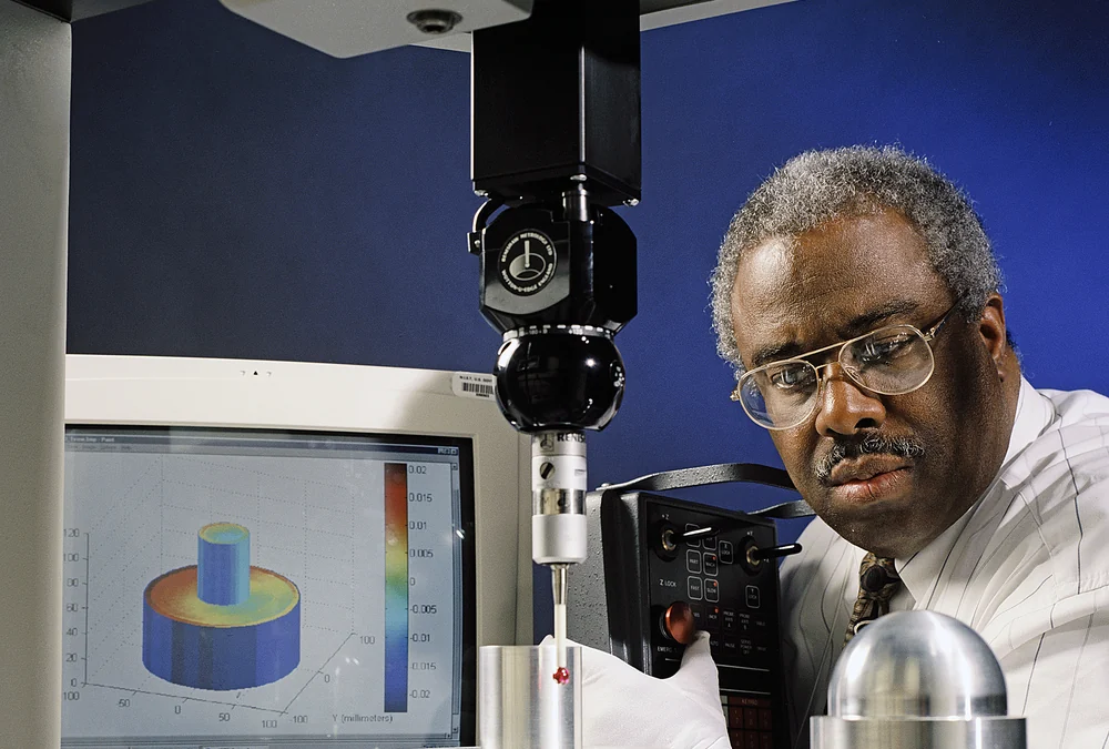 Coordinate measuring machine inspecting a machined part for dimensional verification before CNC production acceptance